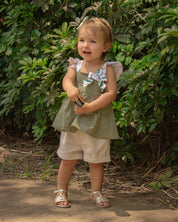 Conjunto blusa verde con detalles de moño y short beige para bebé niña