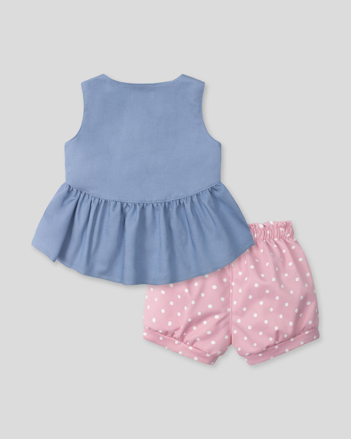 Conjunto blusa azul con moñitos y short rosa con estampado para bebé niña