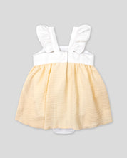 Vestido body en lino blanco y amarillo con detalle de moño para bebé niña