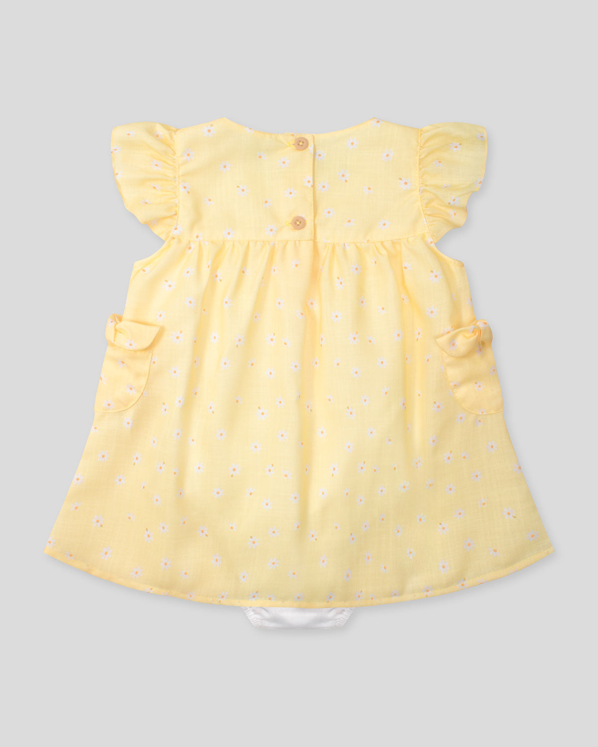 Vestido body amarillo con estampado de flores y bolsillitos en los costados para bebé niña