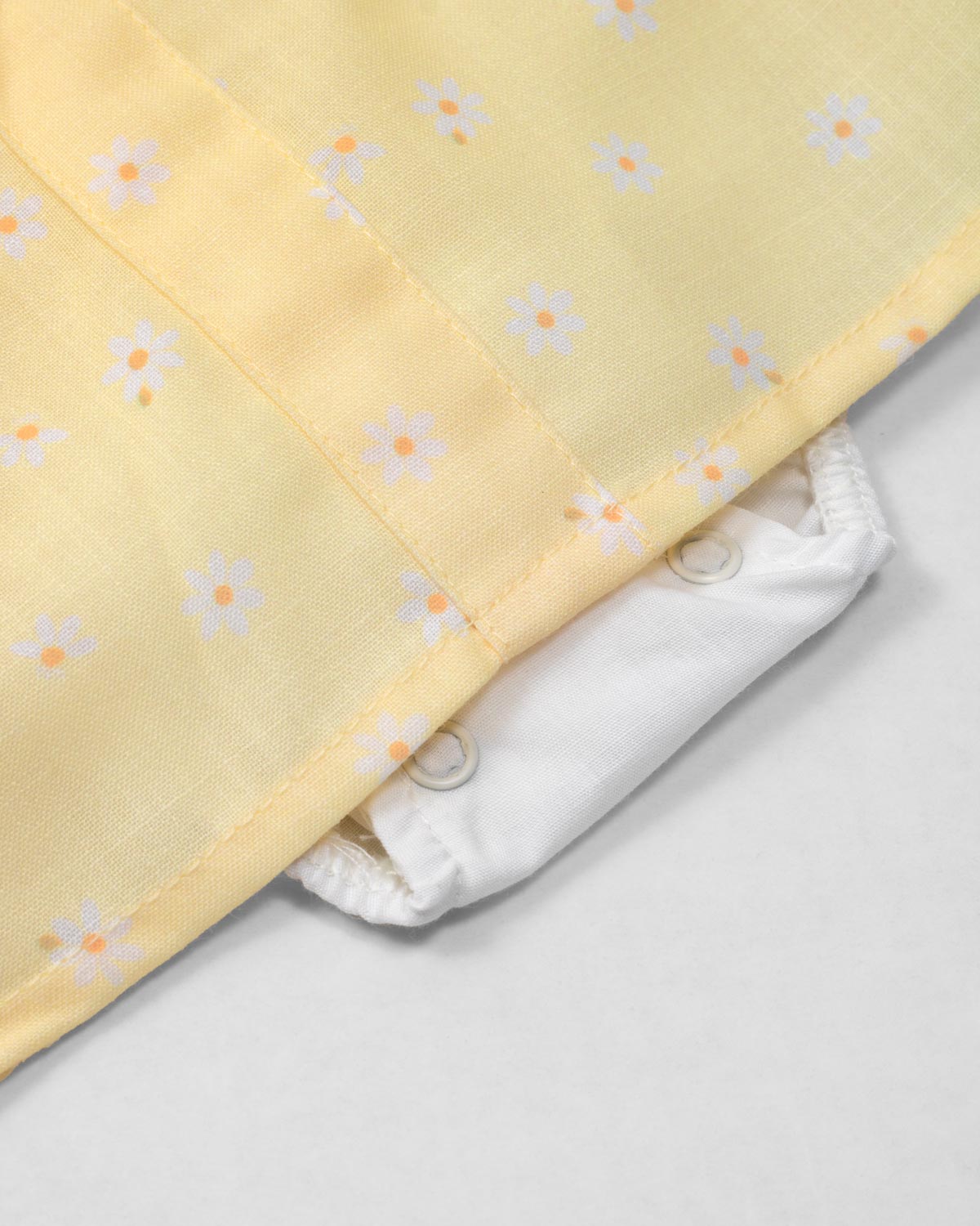 Vestido body amarillo con estampado de flores y bolsillitos en los costados para bebé niña