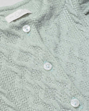 Pijama enteriza en tela tejida verde con botones y boleritos en hombro para bebé niña