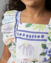 Conjunto blusa estampada de mangas con boleros, moño en espalda y short lila en para niña