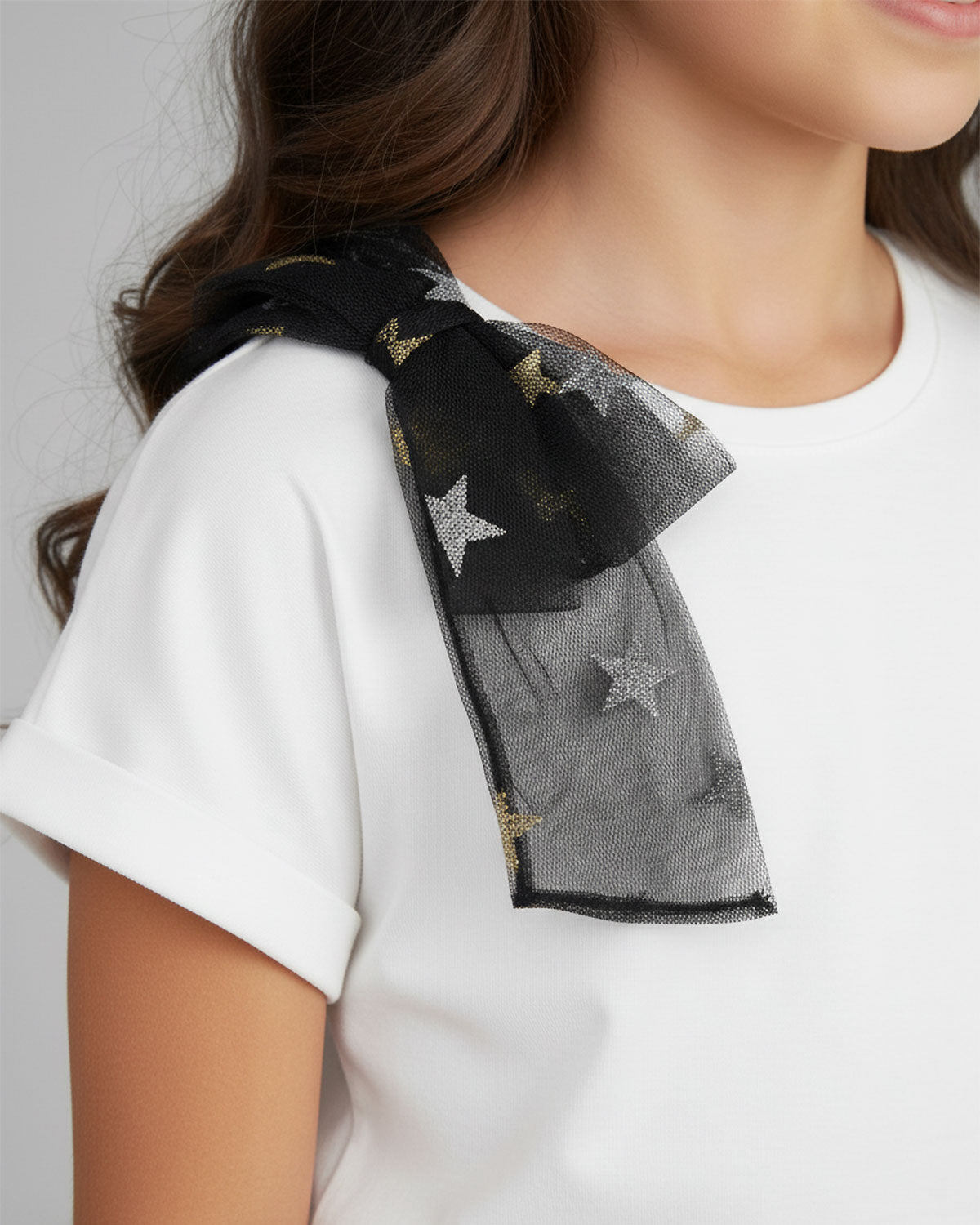 Conjunto camiseta blanca con moño y falda negra en tul con estrellas para niña