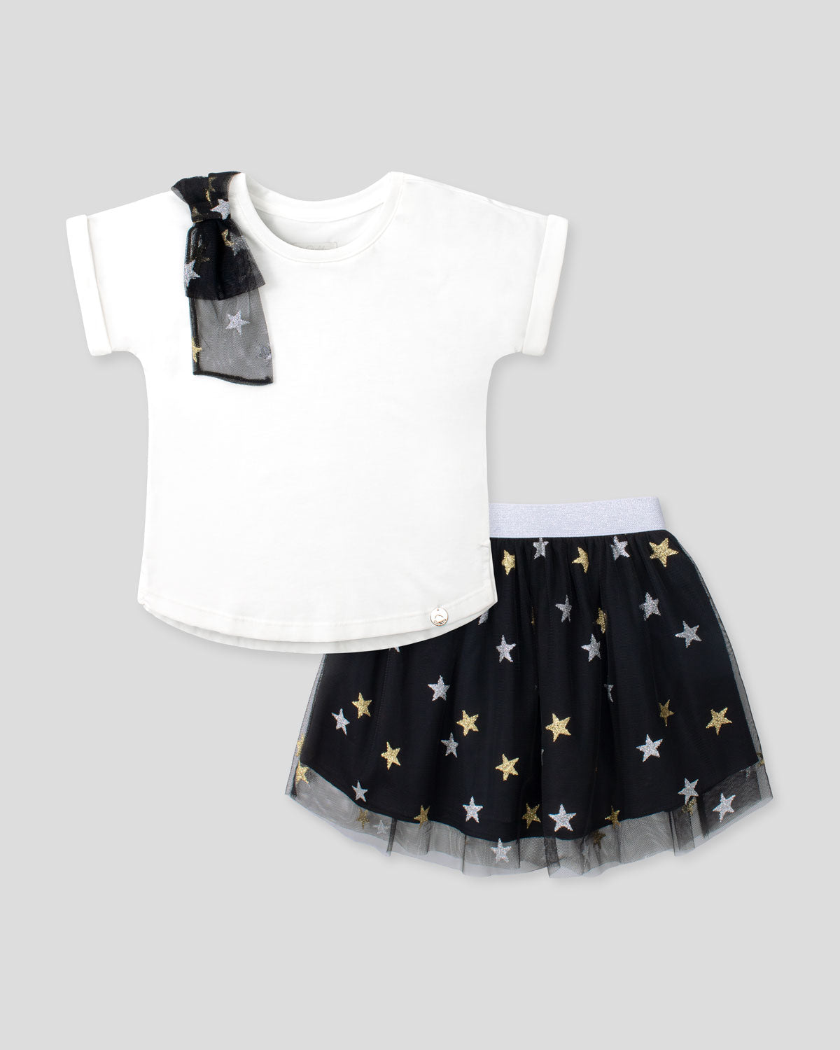 Conjunto camiseta blanca con moño y falda negra con estrellas para niña