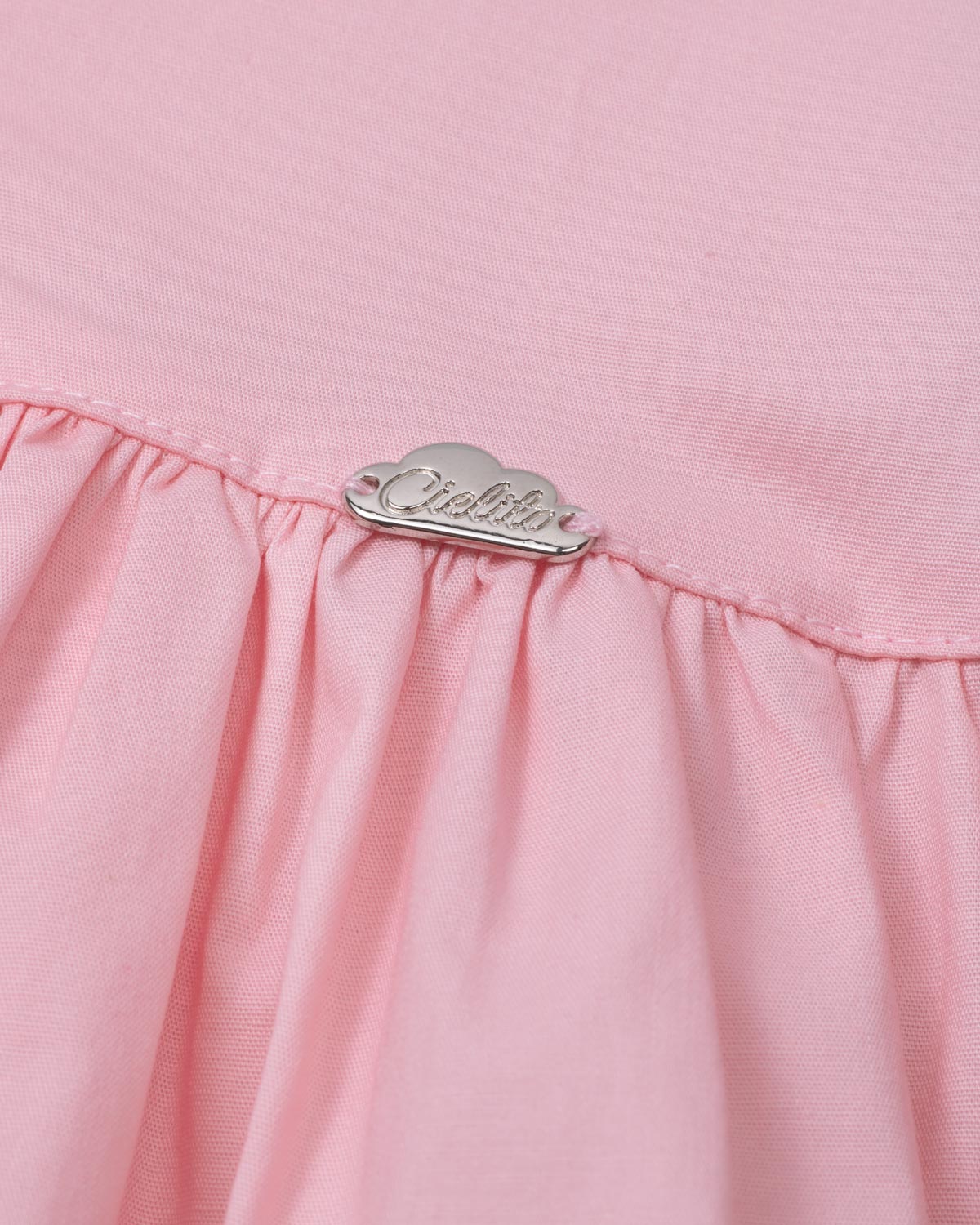 Blusa rosa con detalle de moñitos y bolero para niña