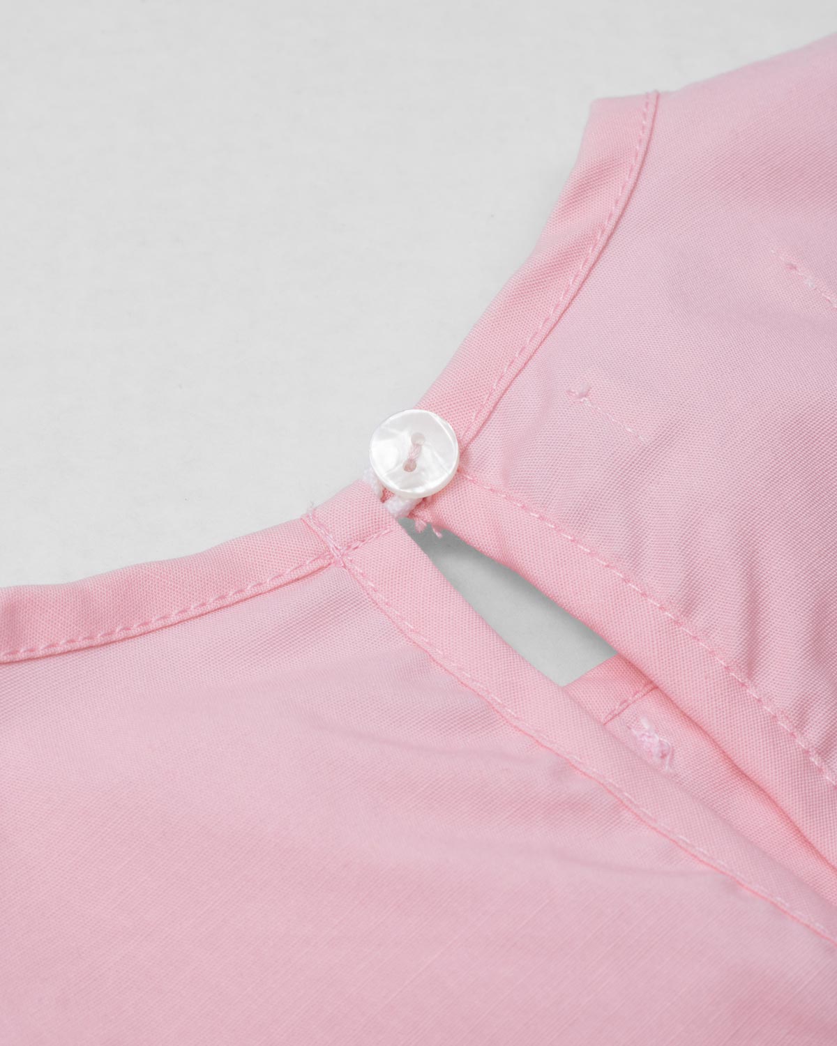 Blusa rosa con detalle de moñitos y bolero para niña