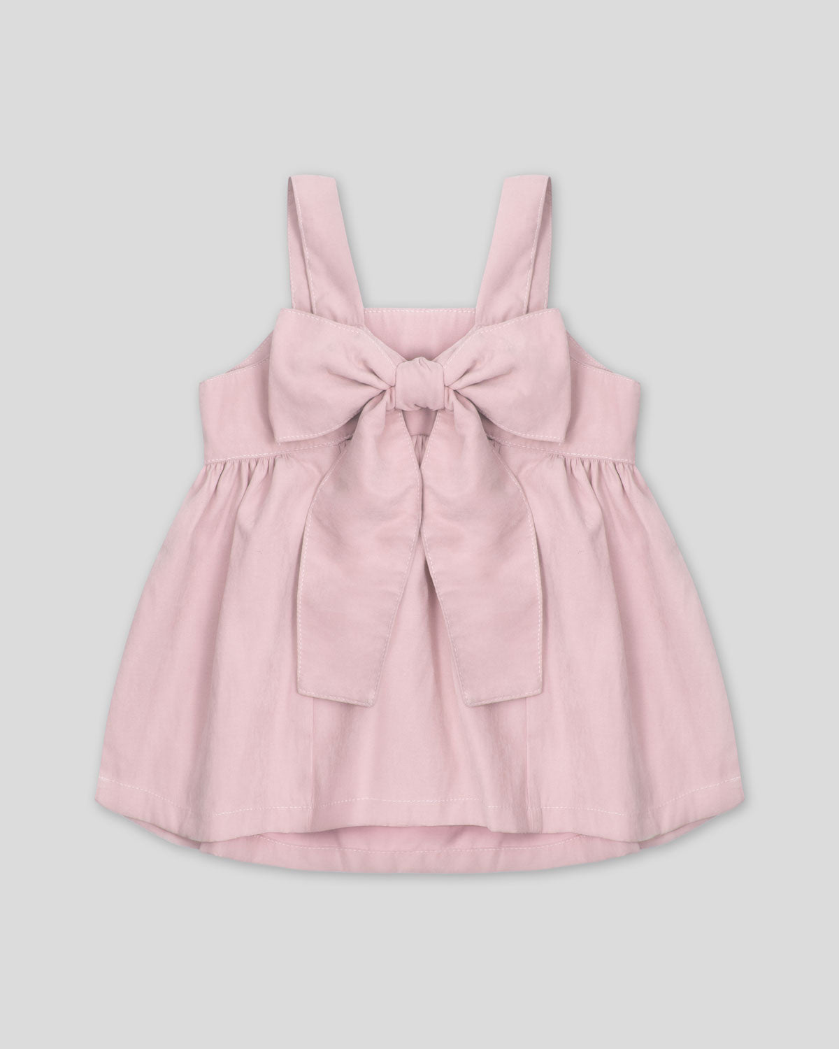 Blusa rosa pastel de tiras con moño en espalda para niña