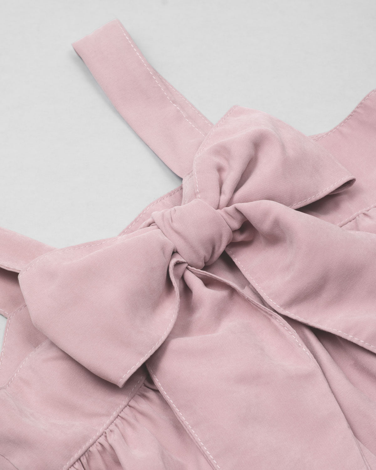 Blusa rosa pastel de tiras con moño en espalda para niña