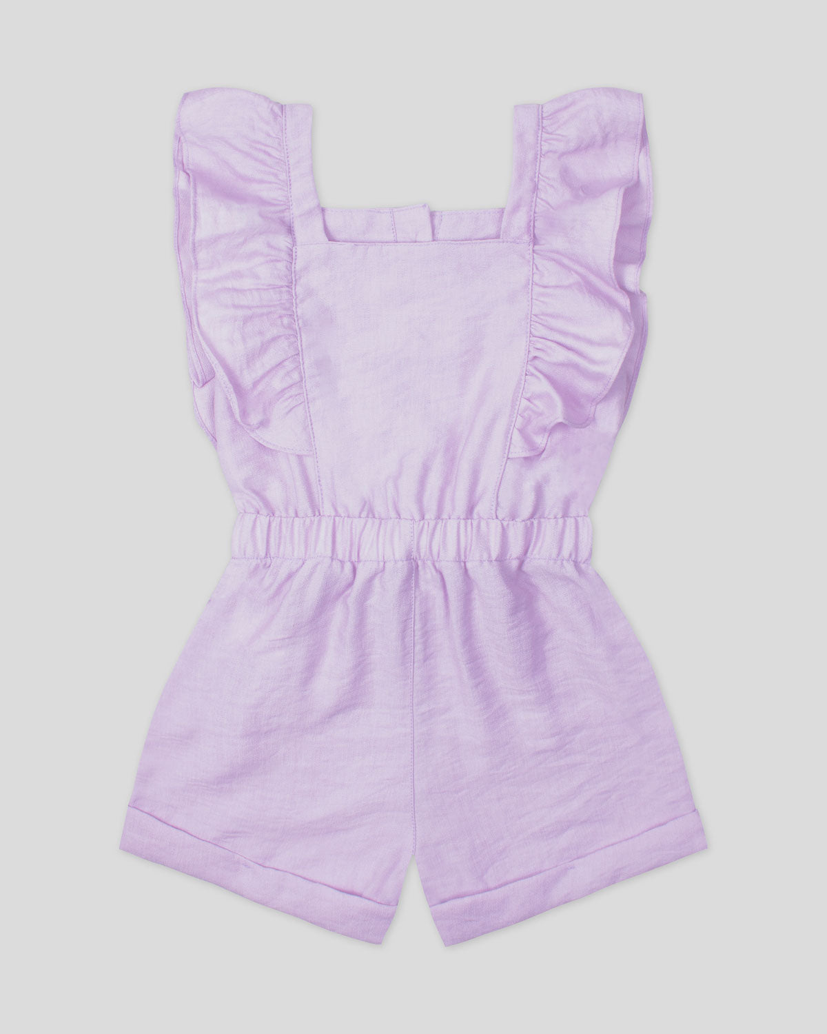 Enterizo corto lila con botones, boleros en manda y detalle de cinturón estampado para niña