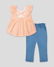 Conjunto blusa de líneas naranjas con bolero en manga y leggins chambray con detalle de moño para bebé niña