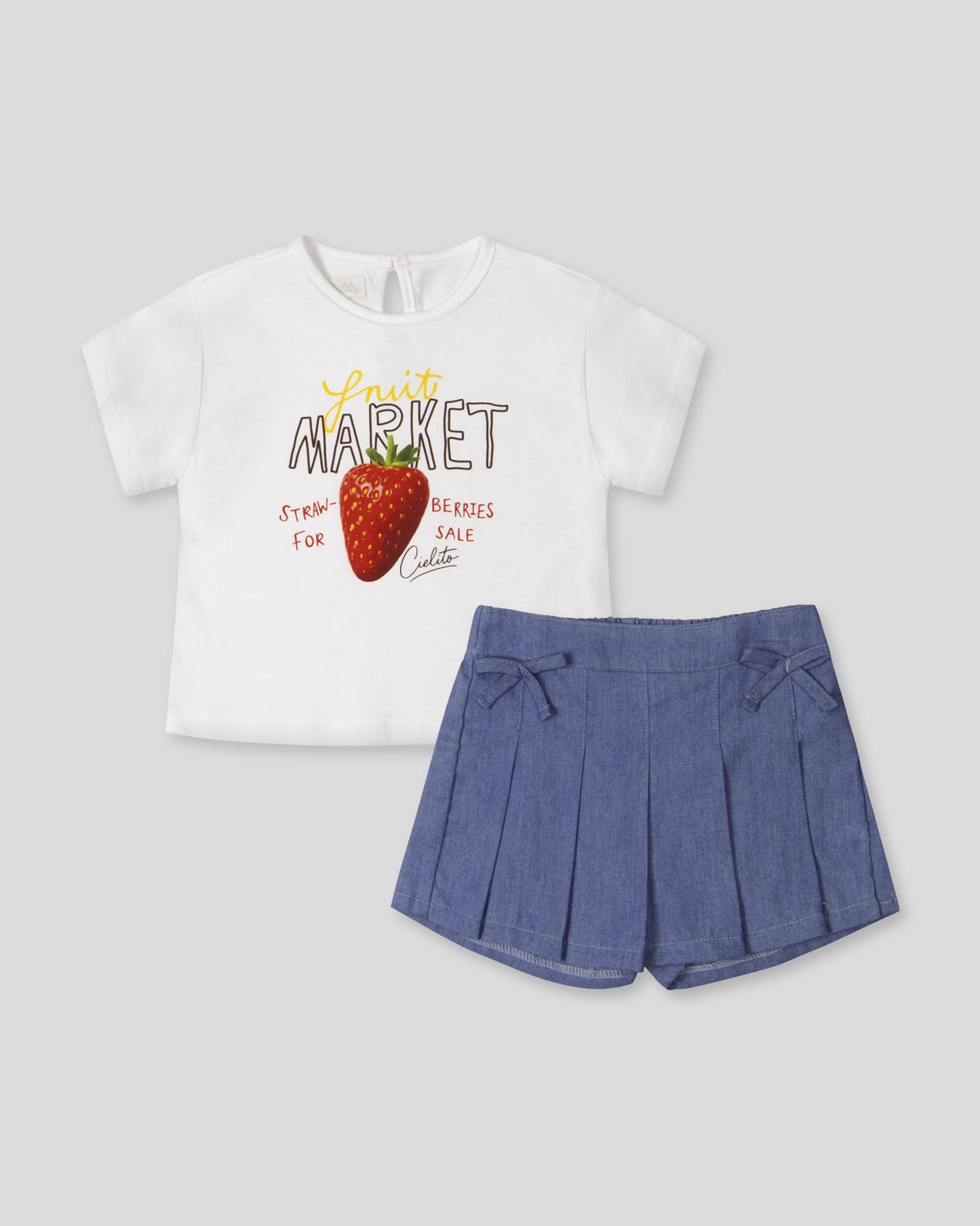 Conjunto blusa blanca estampada "Fruit Market" y falda short azul para bebé niña