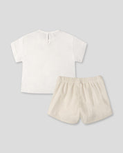 Conjunto camiseta blanca con moños negros y falda short crema para bebé niña