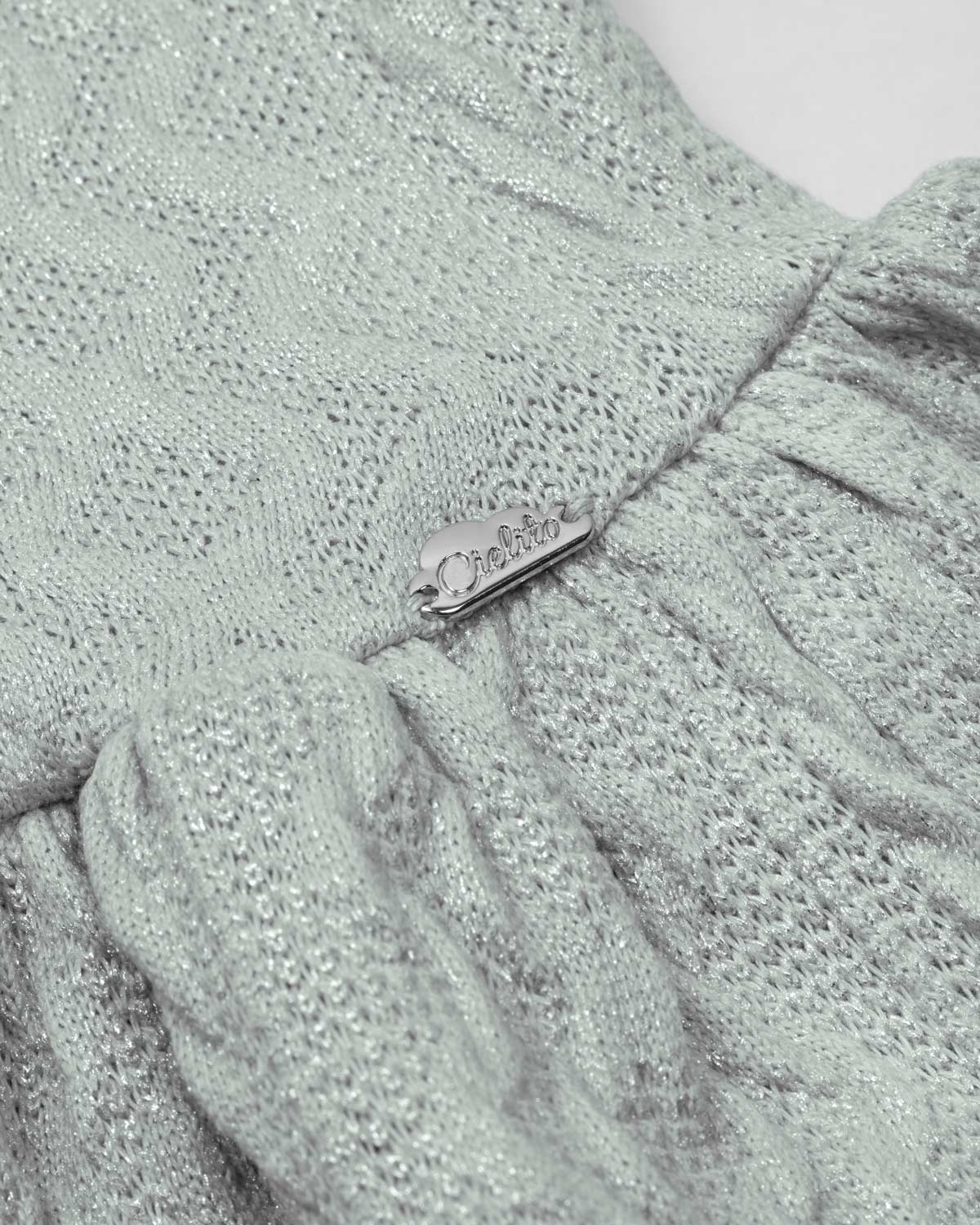 Saco en tela tejida verde con brillos y botones para bebé niña