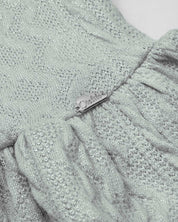 Saco en tela tejida verde con brillos y botones para bebé niña