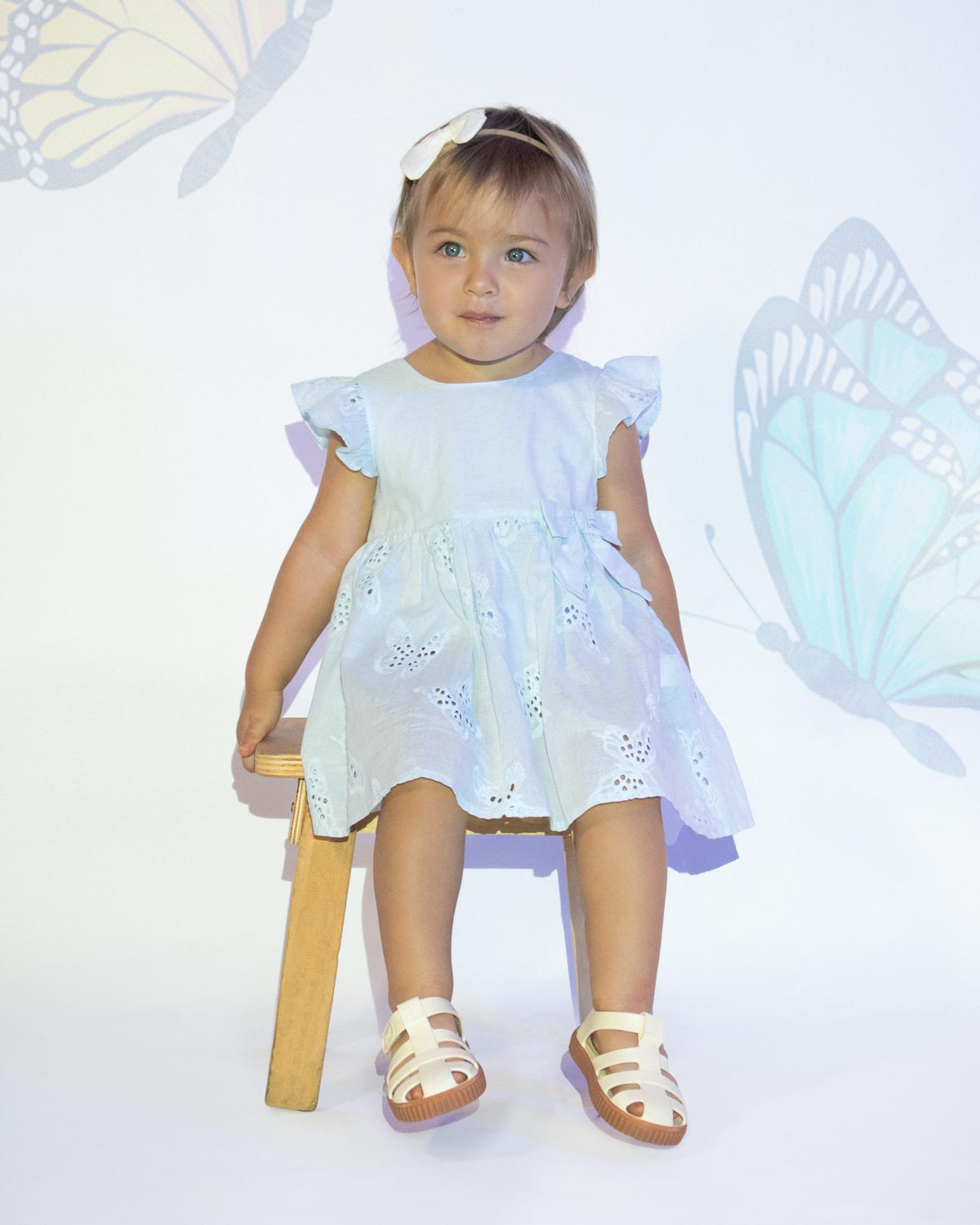 Vestido body azul en tela hoja rota con detalle de moño en cintura para bebé niña