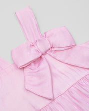 Vestido body rosa en tencel con moñito y visos tornasol para bebé niña