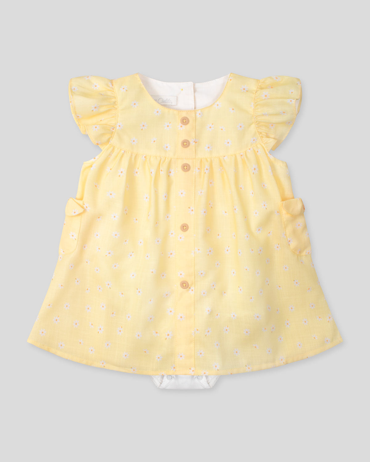 Vestido body amarillo con estampado de flores y bolsillitos en los costados para bebé niña