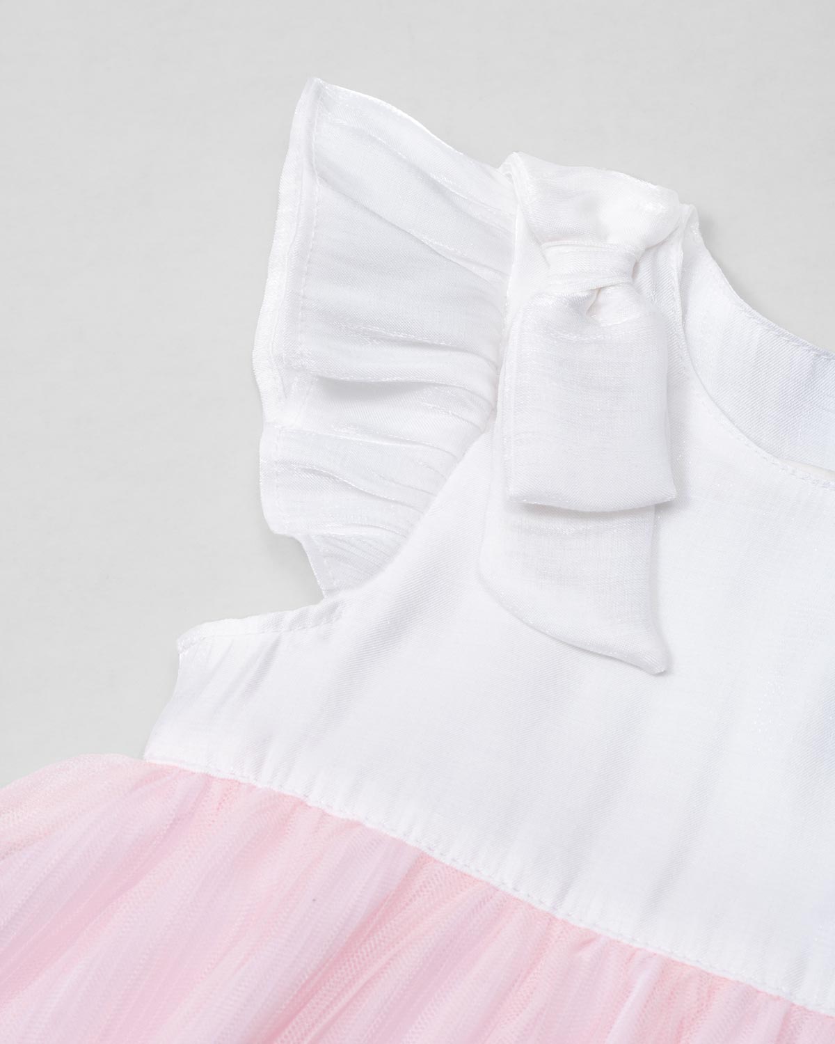 Vestido body en tencel blanco con moñitos y tull plisado rosa para bebé niña