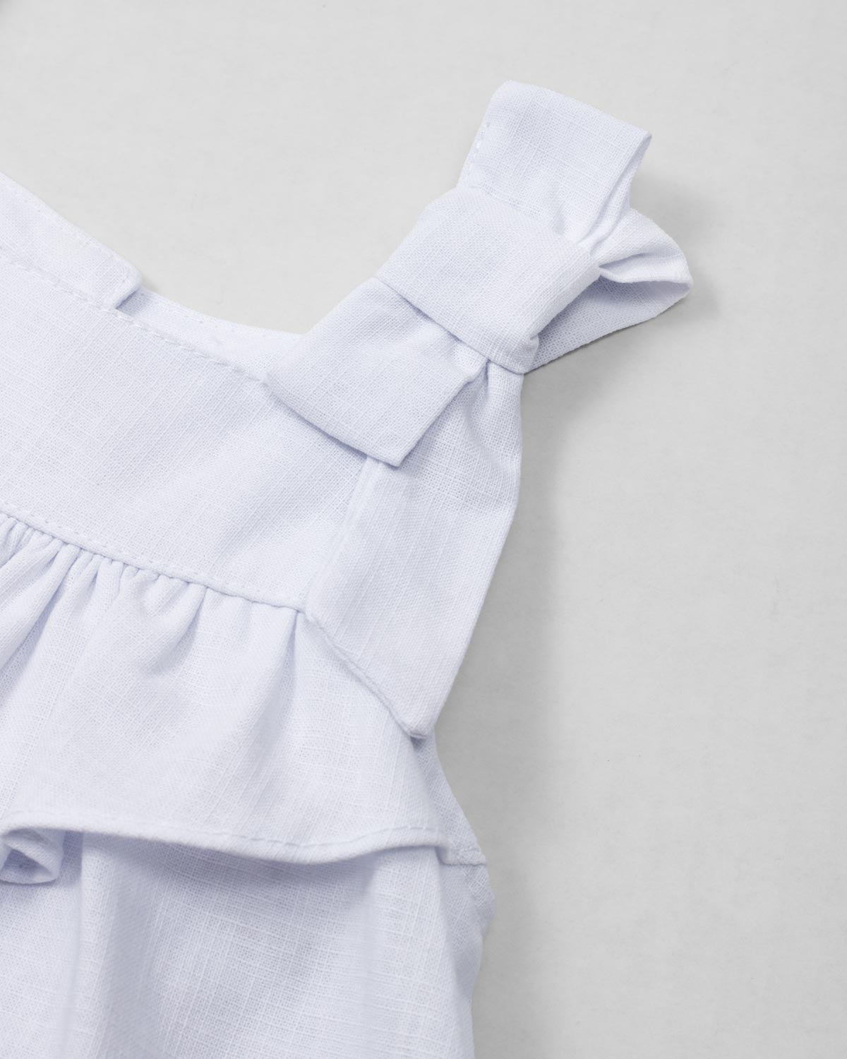 Vestido body en lino blanco con estampado de flores para bebé niña