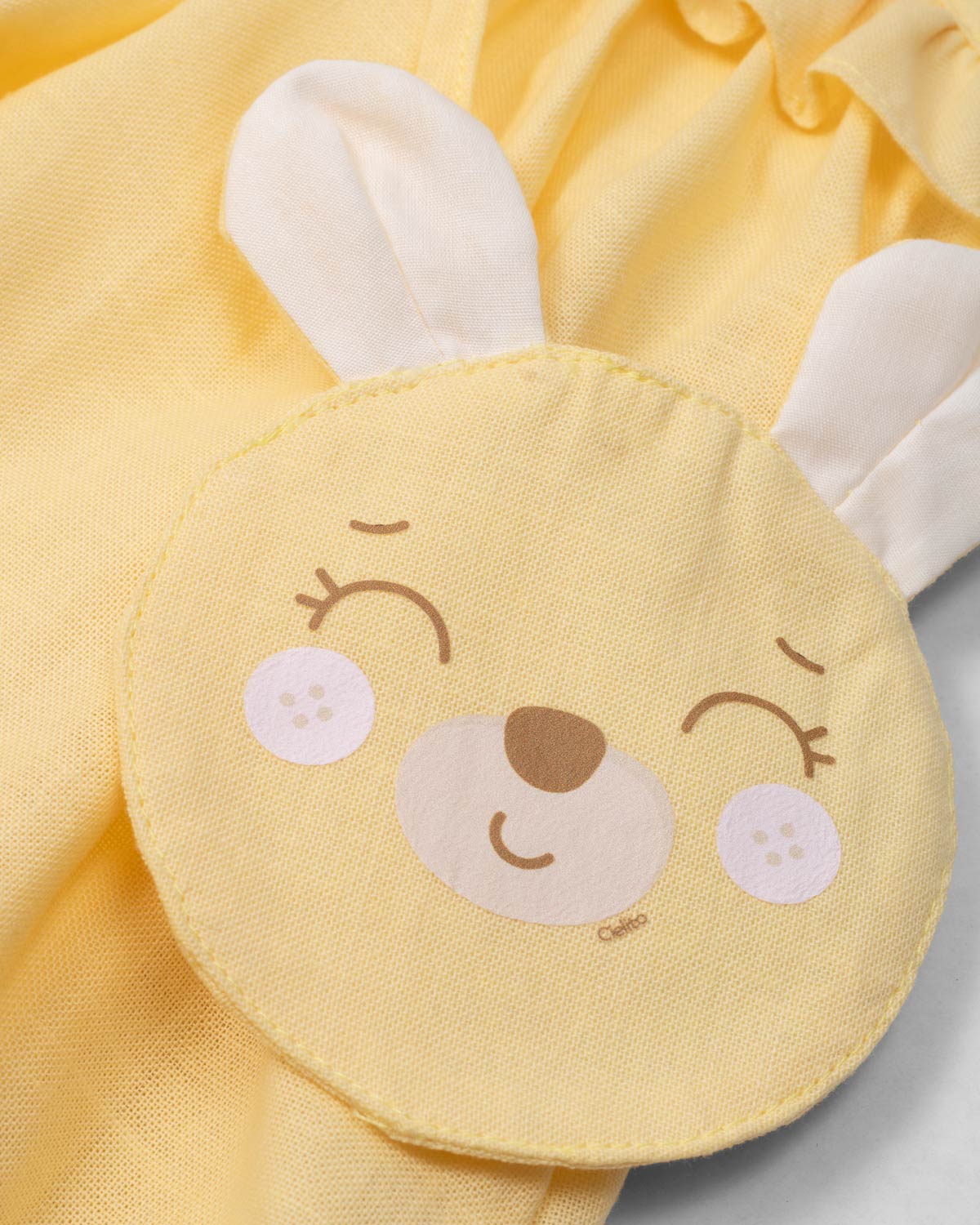 Vestido body en lino amarillo con osito tipo bolso para bebé niña
