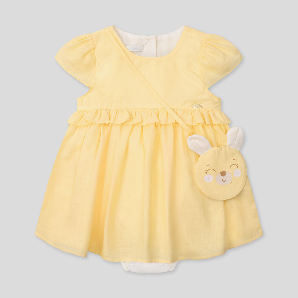 Vestido body en lino amarillo con osito tipo bolso para bebé niña