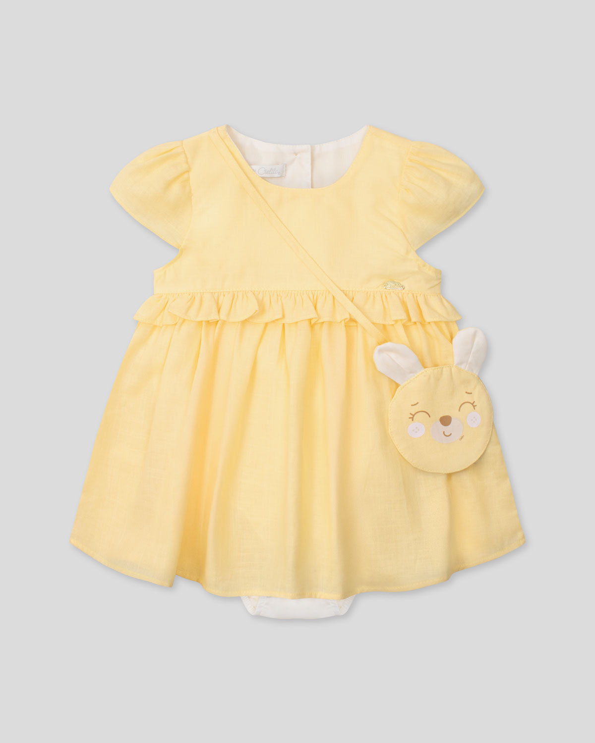 Vestido body en lino amarillo con osito tipo bolso para bebé niña