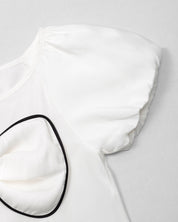 Conjunto blusa blanca con moño y falda negra plisada brillante para niña