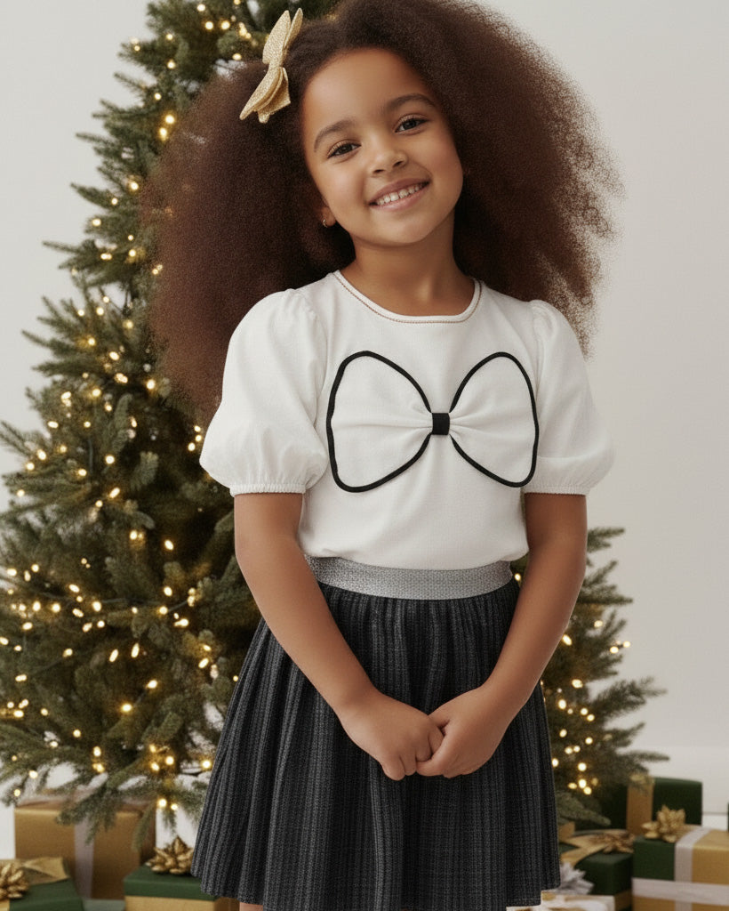 Conjunto blusa blanca con moño y falda negra plisada brillante para niña