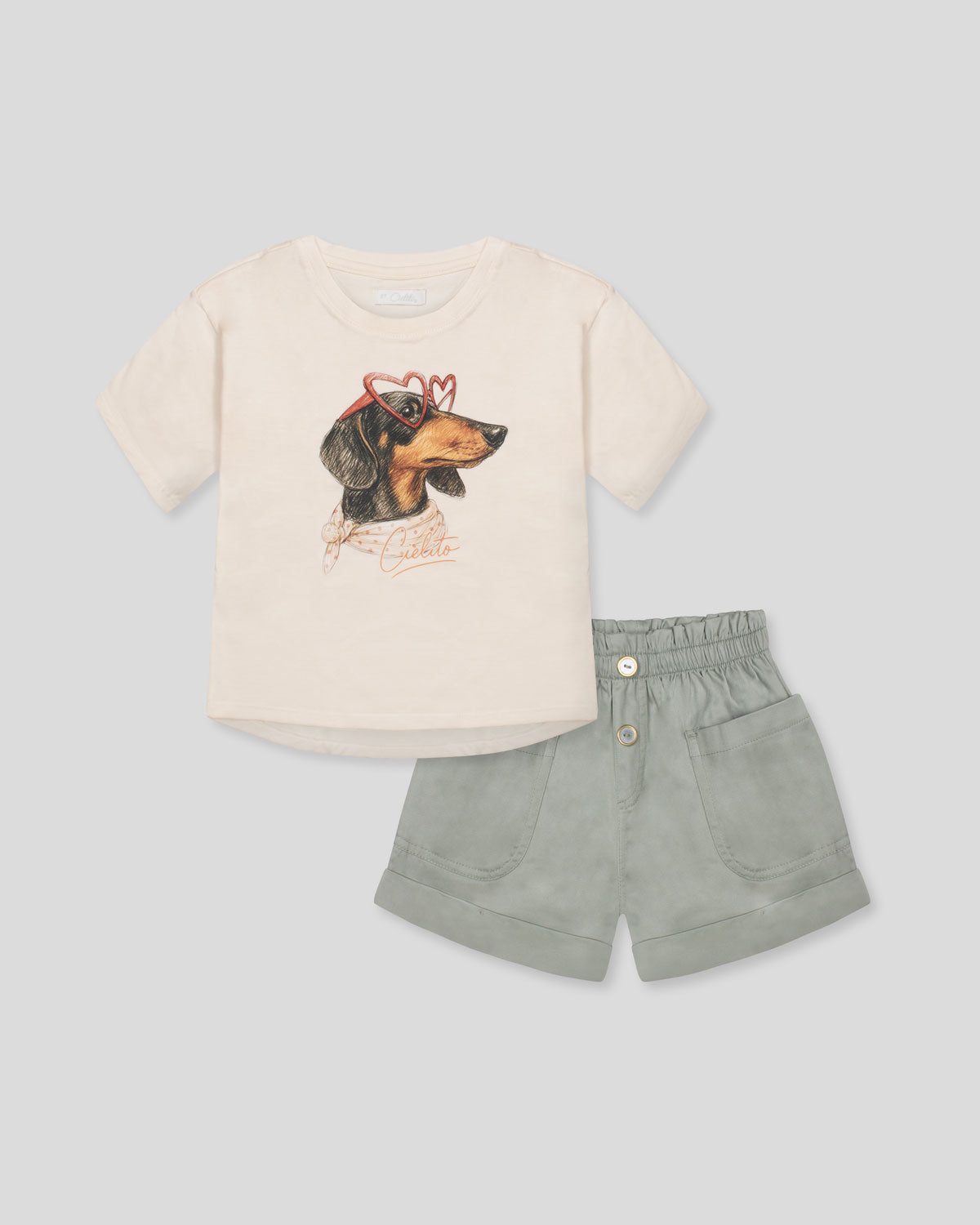 Conjunto blusa crema con estampado de perrito y short verde para niña