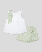 Conjunto blusa blanca con botones, moño y falda short verde estampado para niña