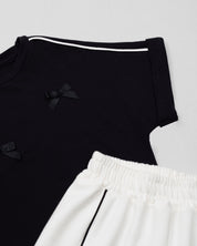 Conjunto blusa negra con moñitos y pantalón blanco para niña