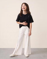 Conjunto blusa negra con moñitos y pantalón blanco para niña