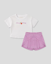Conjunto camiseta blanca estampada y falda short lila con moños para niña