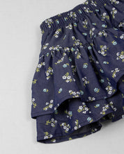 Conjunto blusa blanca con moños, bolero y falda con flores estampadas para niña