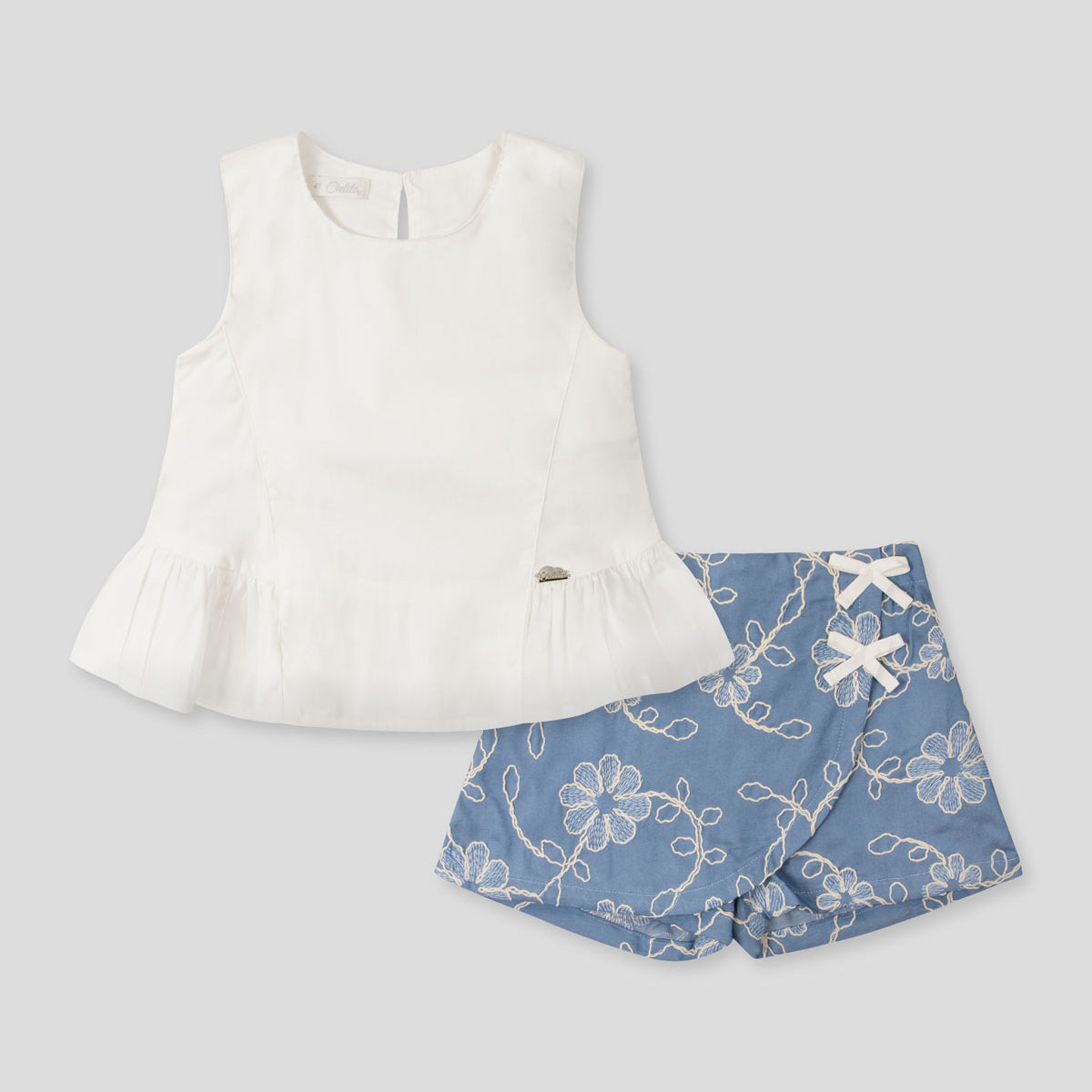 Conjunto blusa blanca y falda short azul con bordado de flores para niña