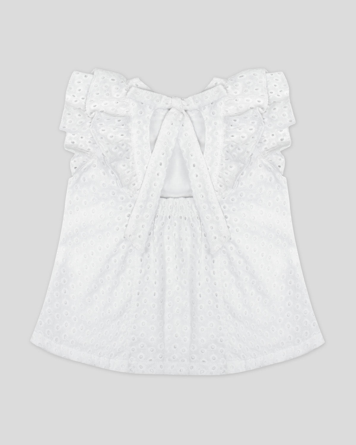 Blusa blanca en tela hoja rota con boleros y moño en espalda para niña