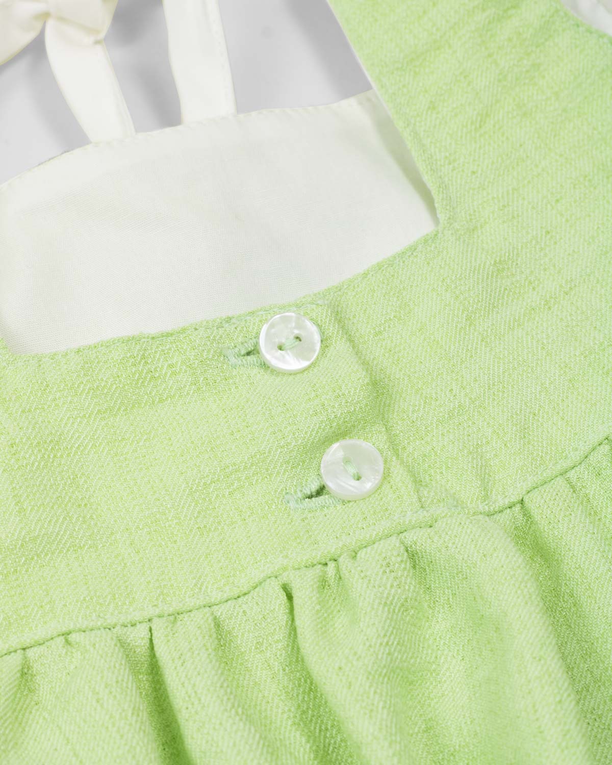 Blusa verde de tiras con detalle de moño para niña