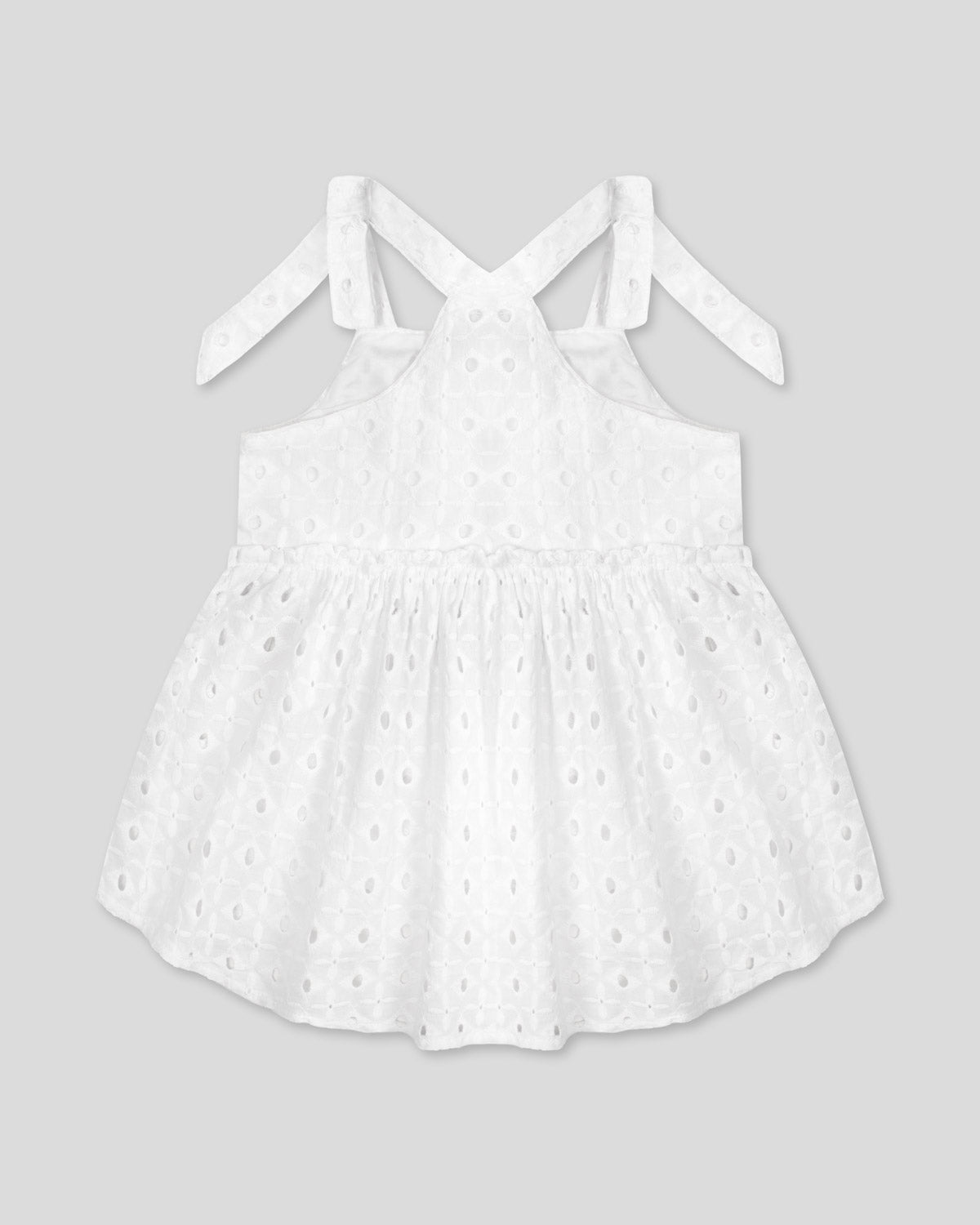 Blusa blanca de tiras con detalle de moño en tela hoja rota para niña