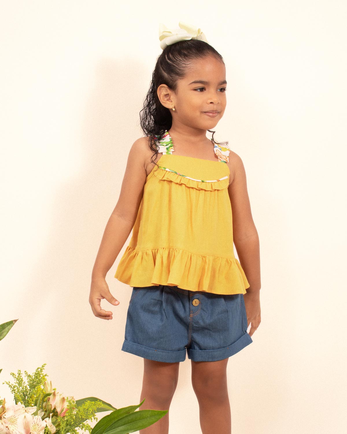 Blusa mostaza con tiras zurcidas y boleros para niña