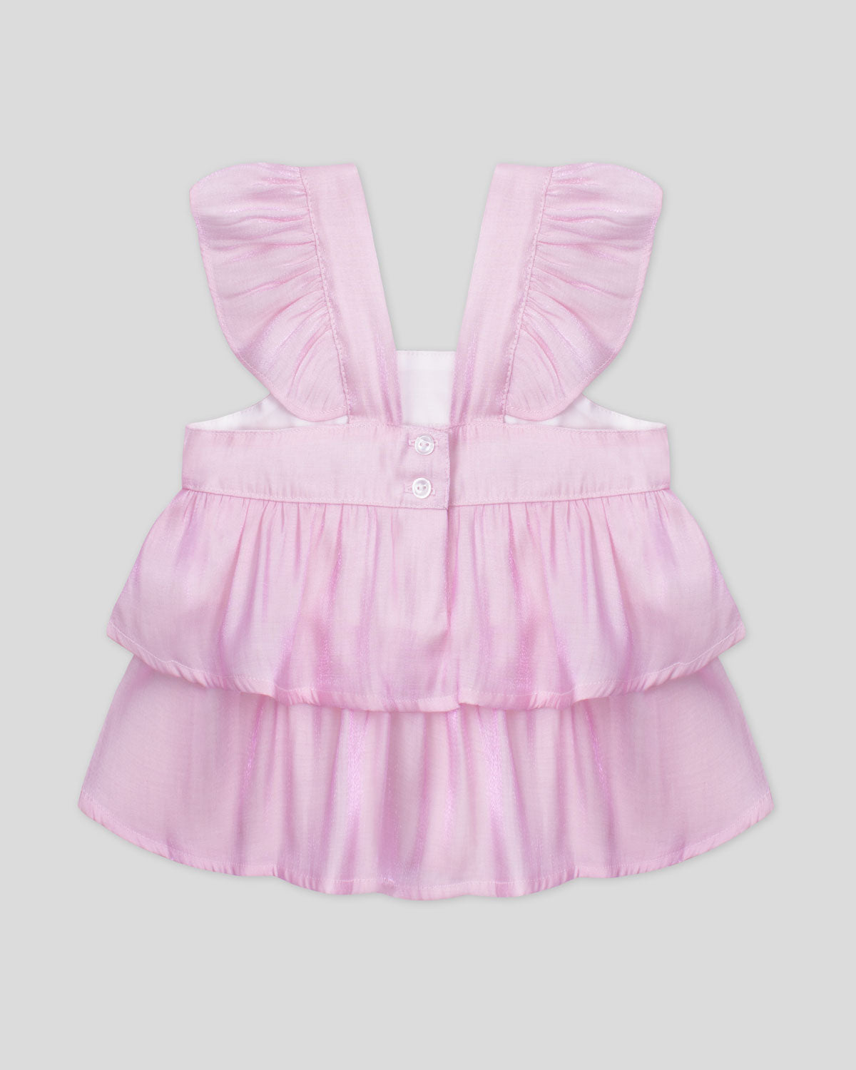 Blusa rosa con boleros y visos tornasol para niña