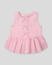 Blusa rosa con detalle de moñitos y bolero para niña
