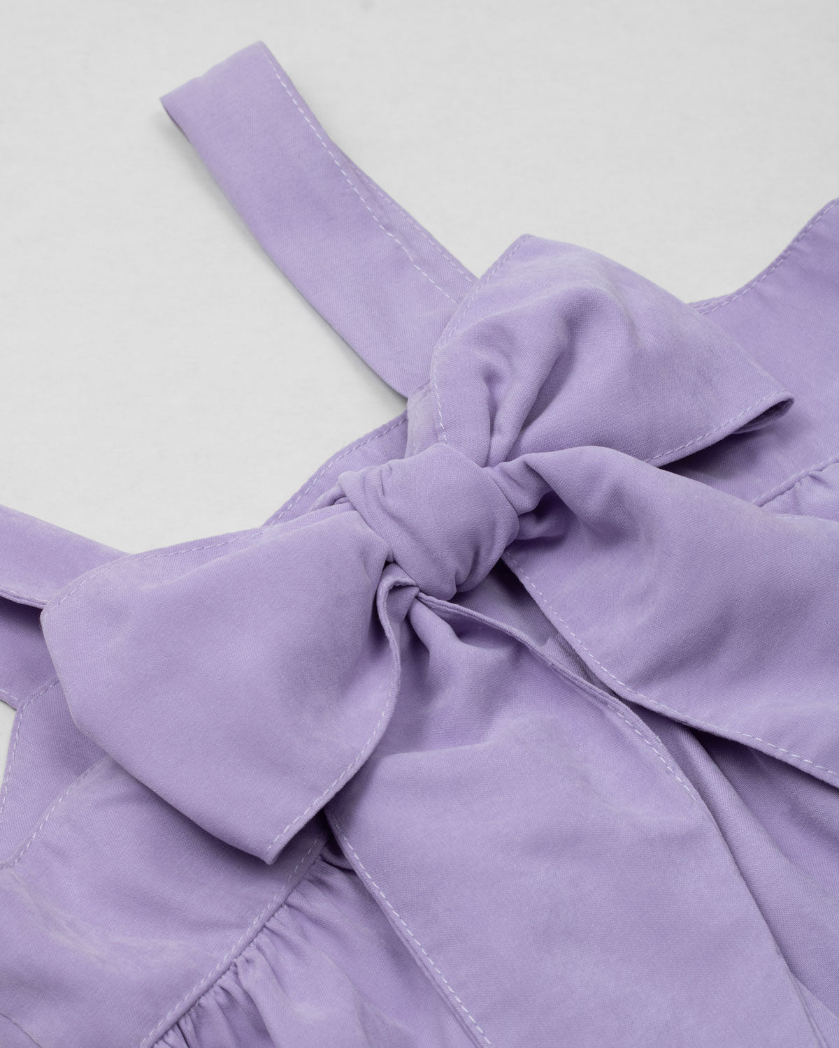 Blusa lila de tiras con moño en espalda para niña