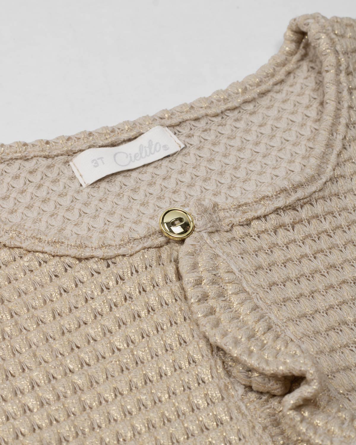 Saco tejido beige con brillos para niña