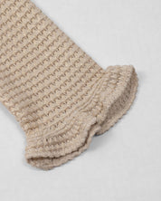 Saco tejido beige con brillos para niña