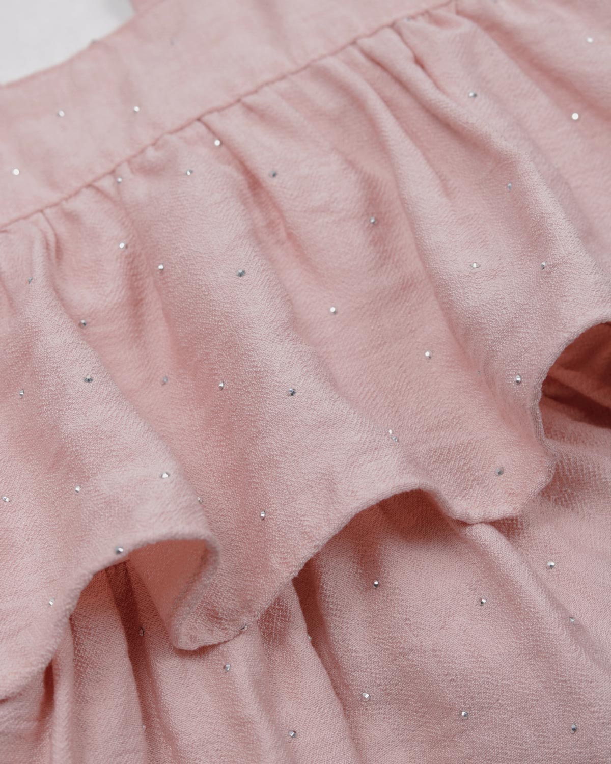 Blusa rosa con brillos y tiras con boleritos para niña