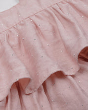 Blusa rosa con brillos y tiras con boleritos para niña