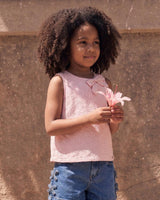 Blusa tela hoja rota rosa con moños para niña