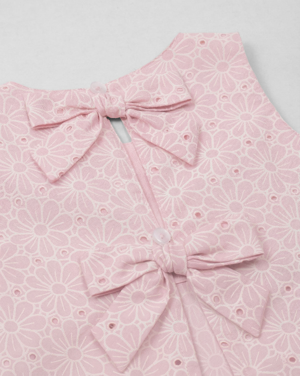 Blusa tela hoja rota rosa con moños para niña