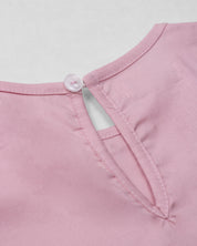 Blusa rosa con moños negros para niña